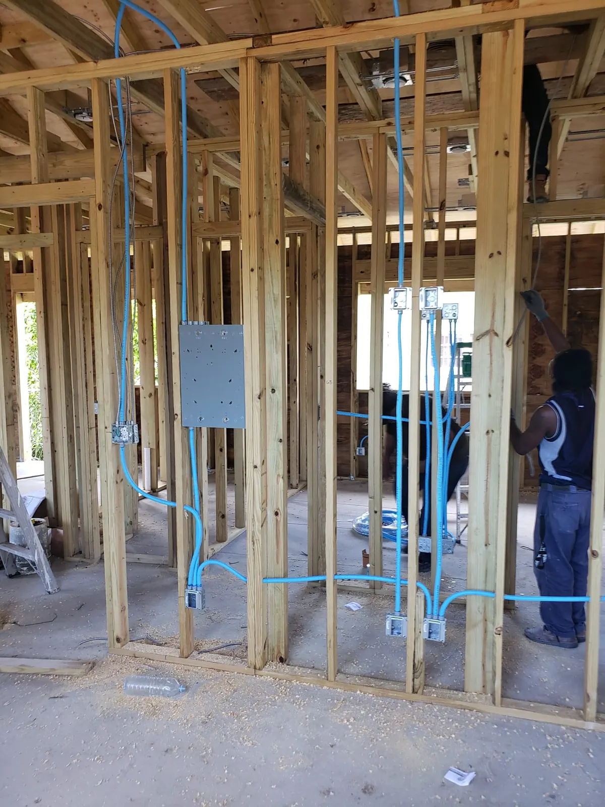 Electrical rough-in with conduit and panel in a framed wall
