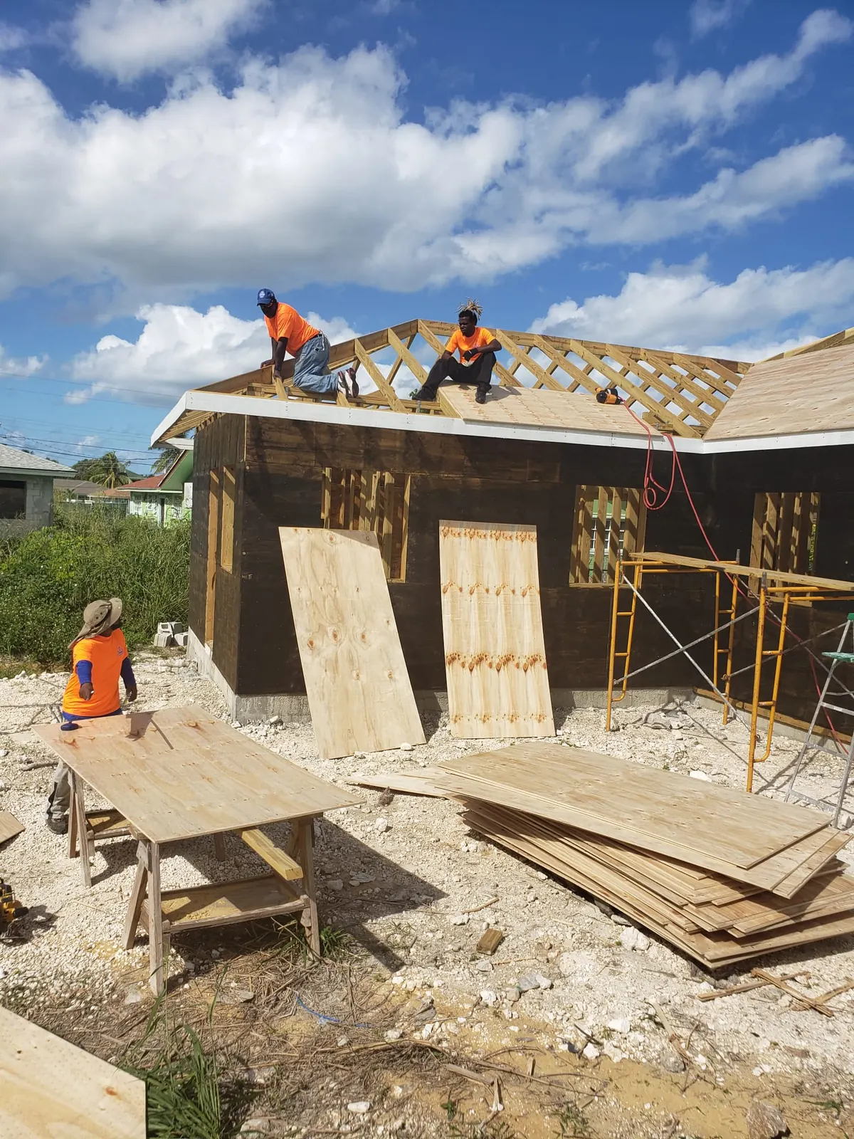 Humble Hands crew installing roof sheathing on a new home